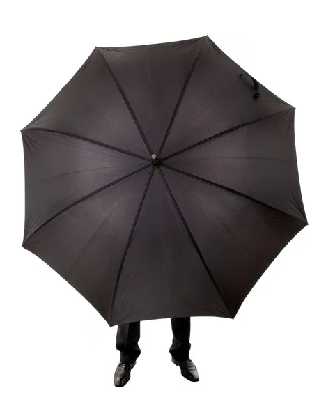 Деловой человек спрятан в зонтике — стоковое фото