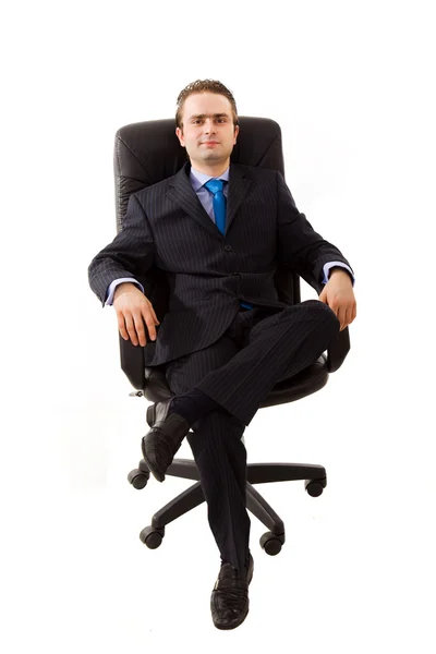 Empresário senta-se na cadeira de escritório Imagens Royalty-Free