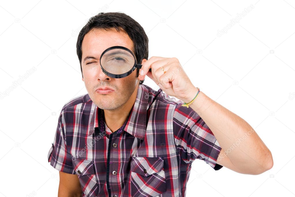 Man looking through magnifying glass