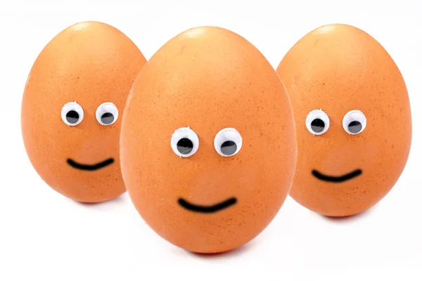 stock image Three eggs with eyes .