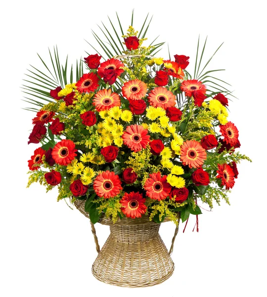 Basket of roses, gerberas and palm leaves — Stock Photo, Image