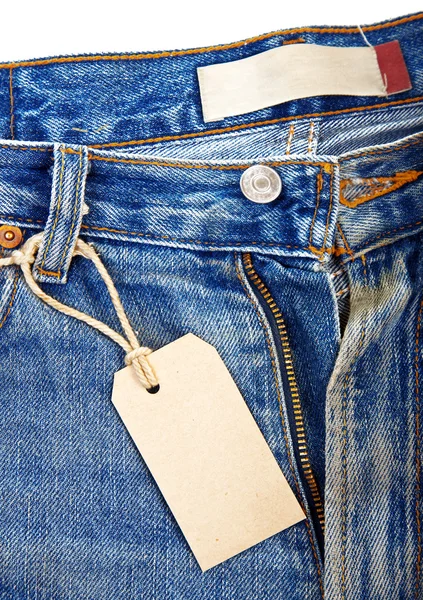 Unbuttoned blue jeans with paper label — Stock Photo, Image