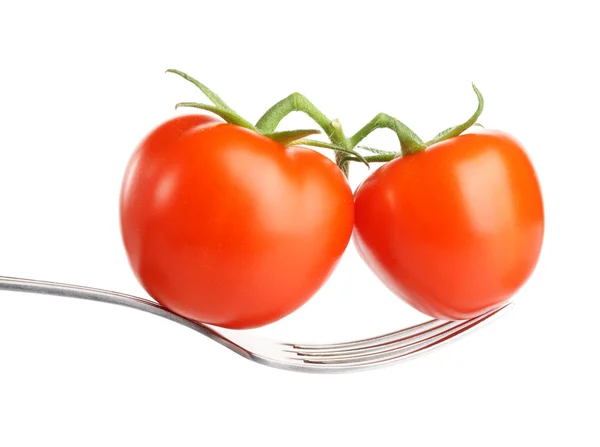 Raw red tomato on fork. Isolated on white background — Stock Photo, Image