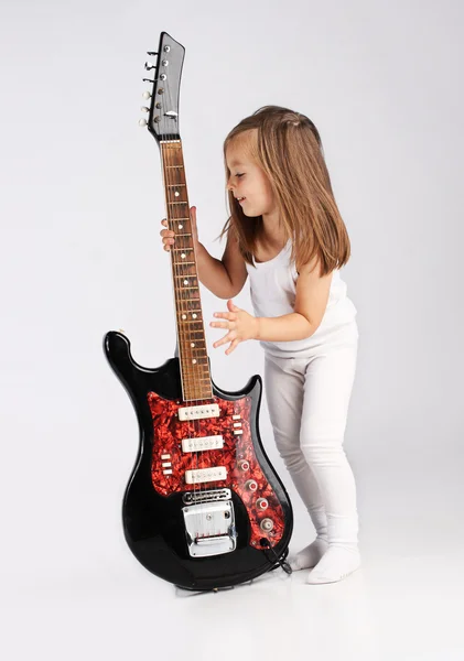 stock image Small child hold red acoustic guitar. Music concept. On gray bac