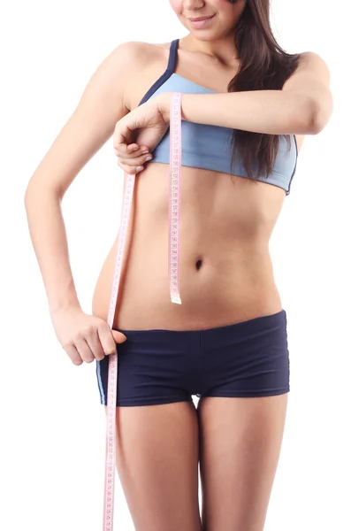 Young woman will measure a waist. Isolated — Stock Photo, Image