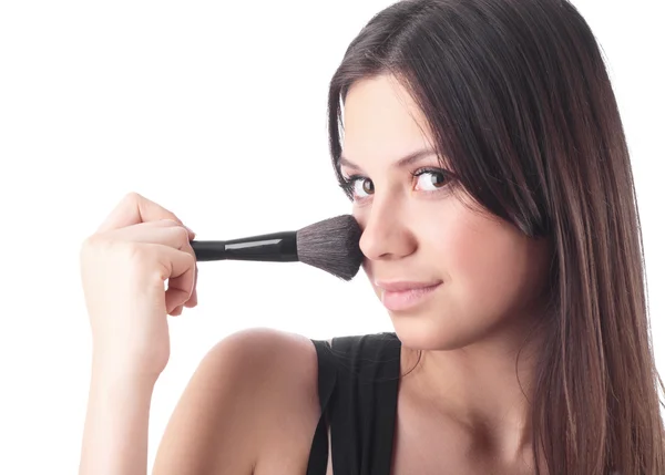 stock image Beautiful young woman with a make-up brush. Isolated