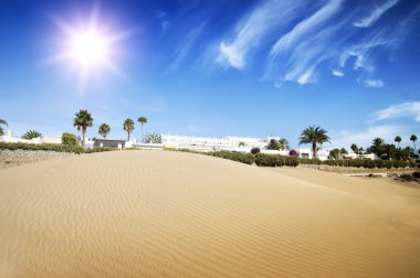 Desert dunes hotel in sunset.
