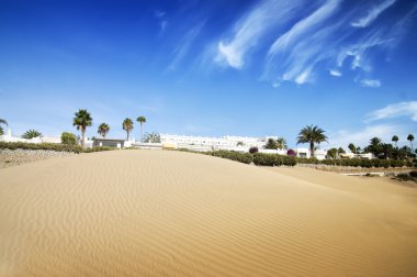 Desert dunes hotel in sunset.