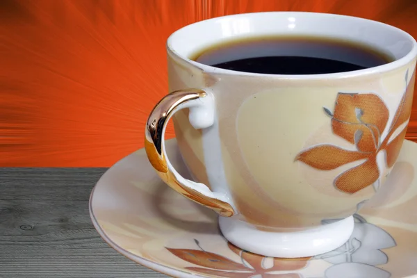 Close-up on cup of coffee over orange background — Stock Photo, Image