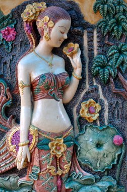 Thai's ancient woman standing in front of a tree. clipart