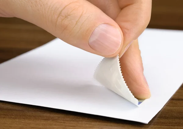 Stamp being pasted onto an envelope — Stock Photo, Image