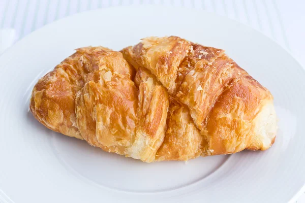 stock image The fresh croissant isolated on white plate