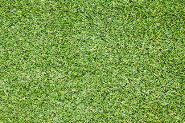Textura de fondo con hierba falsa en un parque infantil público — Foto de Stock