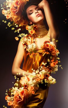 Sensual woman in long yellow dress and flowers clipart