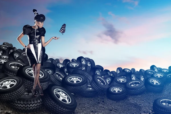 Attractive african woman on tires on the blue sky — Stock Photo, Image