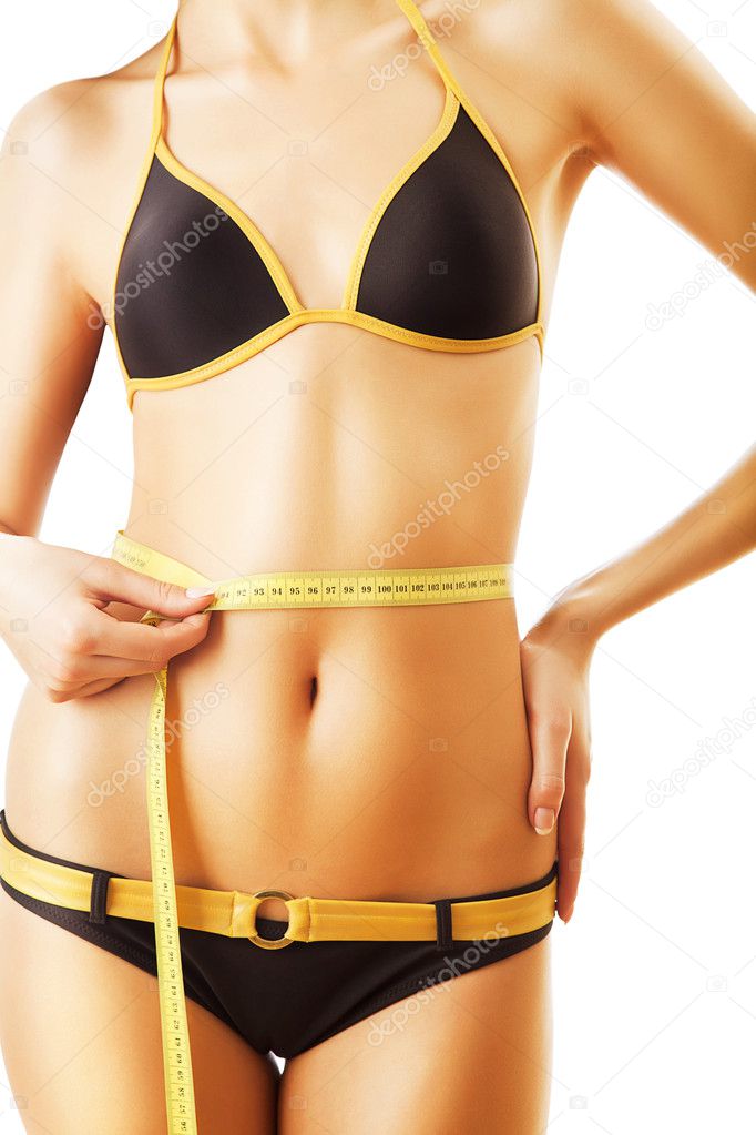 Slim woman body in swimsuit with measure