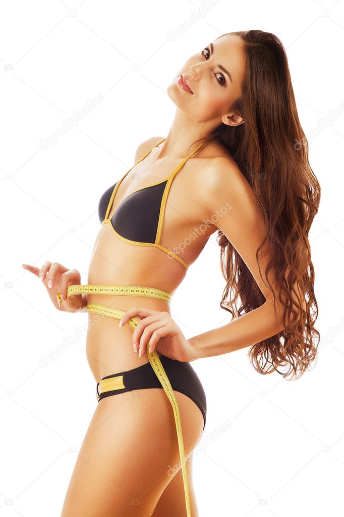 Smiling slimming woman with long hair in swimsuit with measure