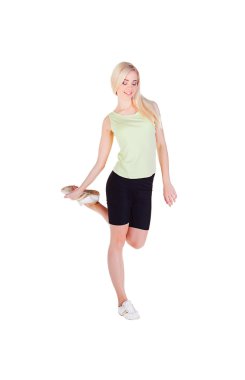 Girl doing her exercise on one leg and smiling clipart