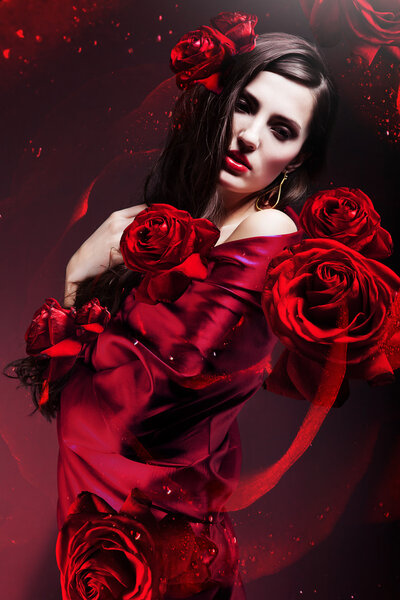Beautiful woman in red fabric with red roses