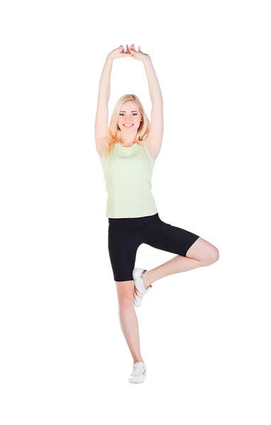 Chica haciendo su ejercicio en pose de garza con la pierna izquierda — Foto de Stock