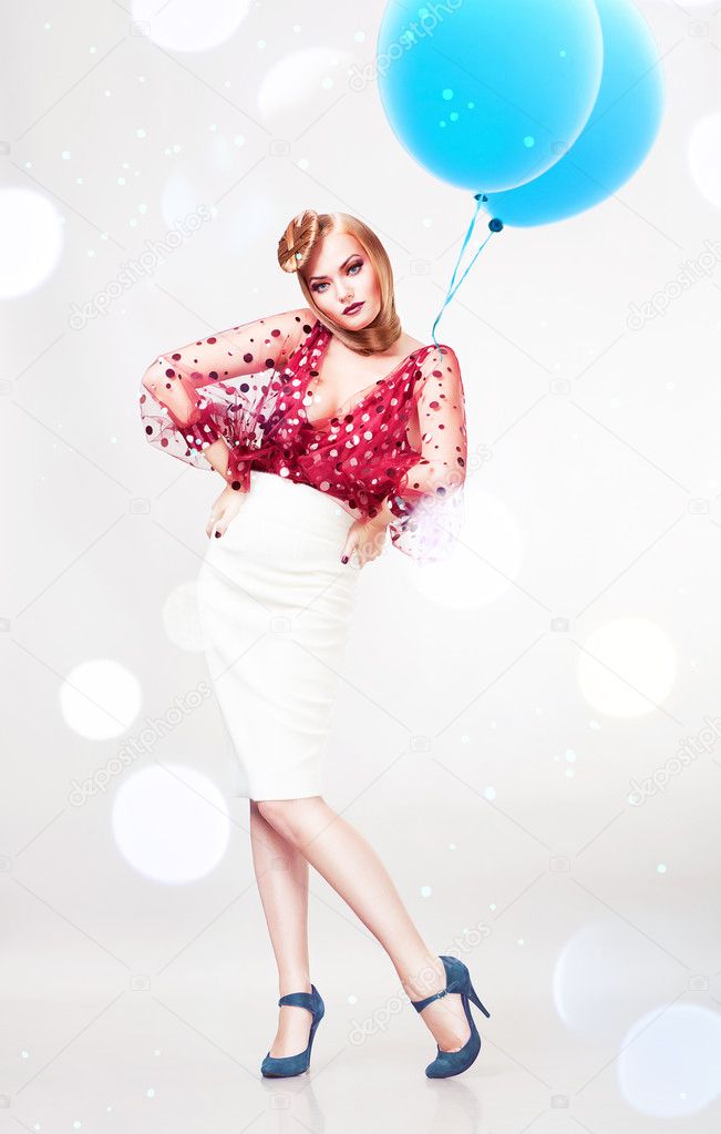 Woman in red blouse and white skirt with blue balloons