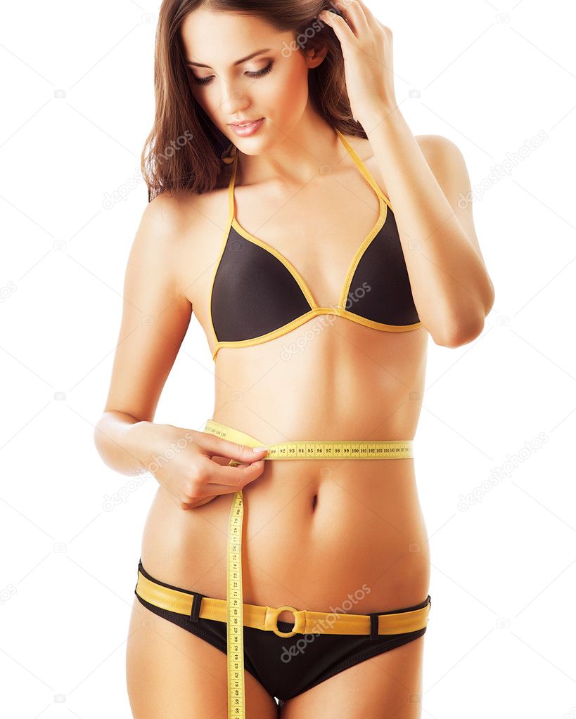 Healthy attractive woman with perfect body and measure in hand