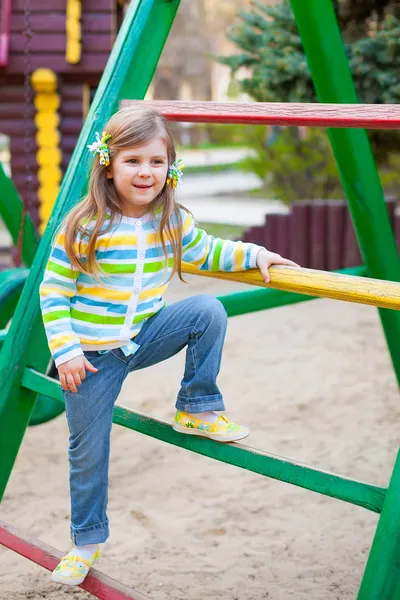 A cute young girl having fun on the playgroung — Stock Photo, Image