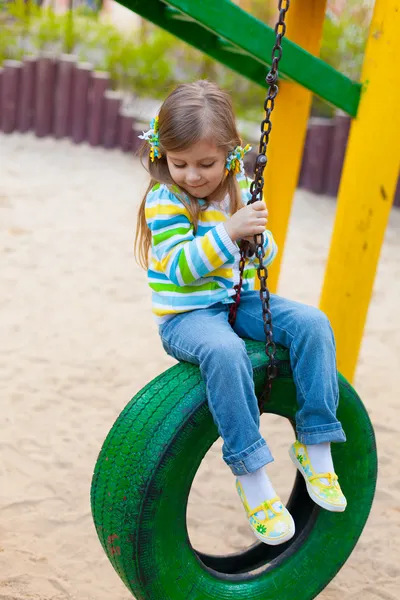 Happy childhood - portrait of swinging girl — Stock Photo, Image