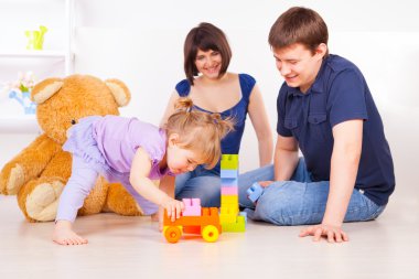 Happy familly playing playing with blocks clipart