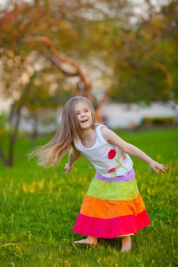 Cute little girl having fun in summer park