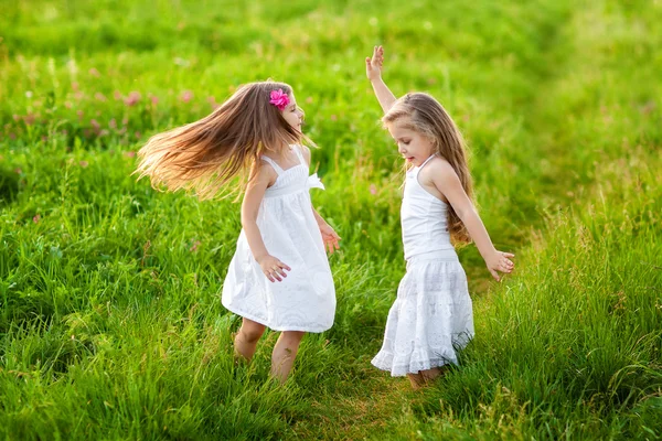Deux jolies filles jouant sur prairie — Photo