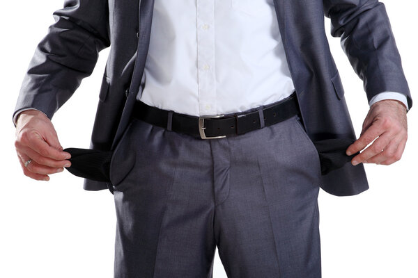 Business man in a suit standing with his hand showing his empty pockets