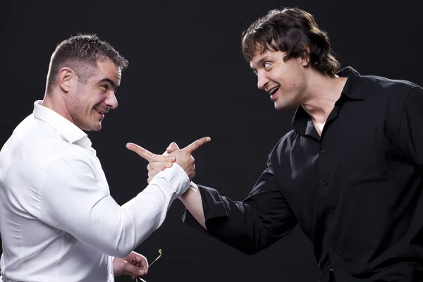 Male friends pointing at each other — Stock Photo, Image