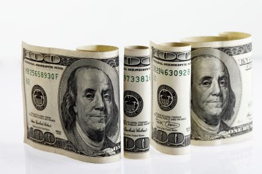 Four rolled hundred dollar bills 2 clipart