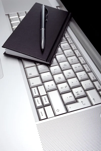 Silver lap top and black pocket planner — Stock Photo, Image