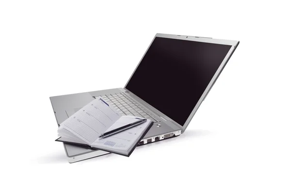 Silberner Laptop und geöffneter Taschenplaner — Stockfoto