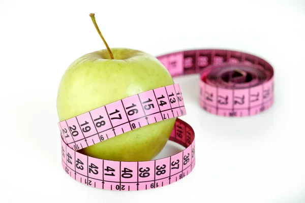 Rózsaszín szabás mérő és az apple — Stock Fotó