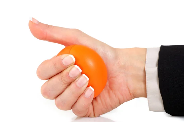 Squeezing an orange stress ball — Stock Photo, Image