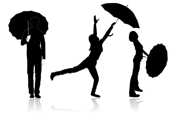 Силуэты молодых с зонтиками — стоковое фото