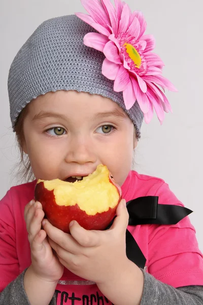 Little girl bites the big apple — Stock Photo, Image