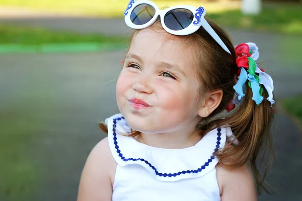 Девушка в солнечных очках обманула их щеки — стоковое фото