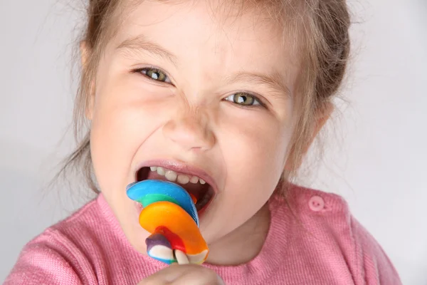 Girl with a big lollipop hamming — Stock Photo, Image