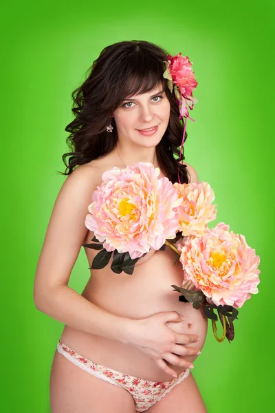 Terhes lány virággal — Stock Fotó
