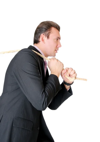 Man in suit pulling a rope — Stock Photo, Image