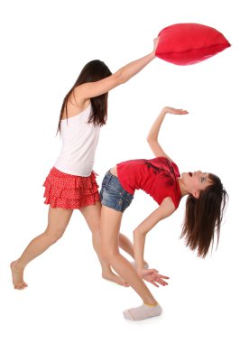 Two girls fighting on the pillows clipart