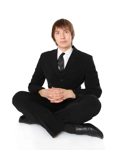Geschäftsmann sitzt auf dem Boden und meditiert — Stockfoto