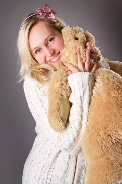 Blond woman and a stuffed toy — Stock Photo, Image
