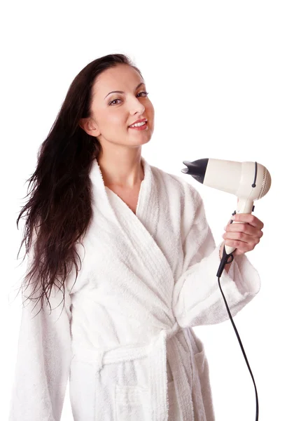 Mulher está secando o cabelo — Fotografia de Stock
