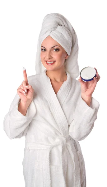 stock image Woman in bathrobe is putting the cream