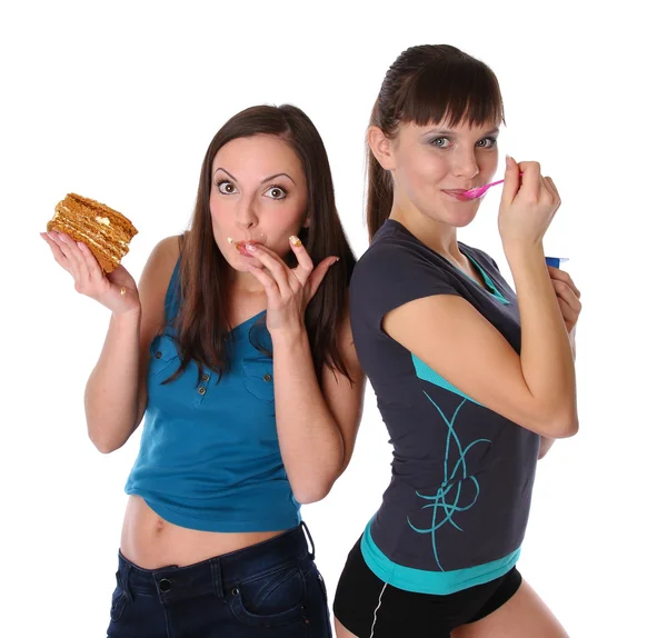 Gorda y delgada niñas comiendo — Foto de Stock